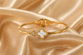 Gold Tone Mother of Pearl Clover Charm with Zirconia Accent Bangle Bracelet for Women - Sleek Finish
