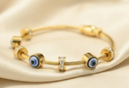 Gold Tone Elegant Lucky Eye Motifs Bangle Bracelet for Women- Glossy Finish (Baby Size)